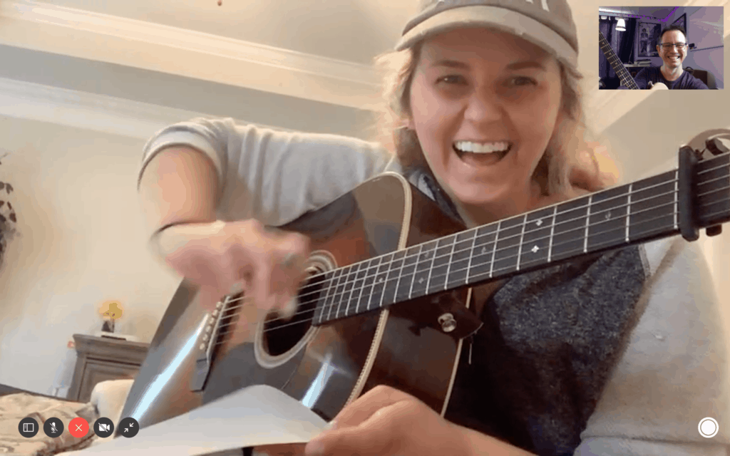 Jess Adams in online guitar lesson with acoustic guitar.