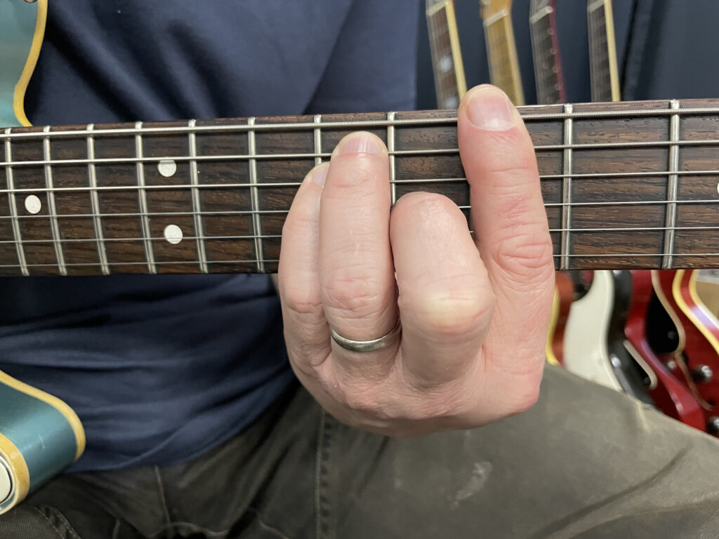 Hand Position of a Barre Chord on the Guitar Neck - Green Hills Guitar Studio