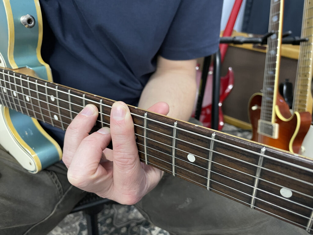 Elbow and Hand Position to Play a Barre Chord on Guitar - Green Hills Guitar Studio