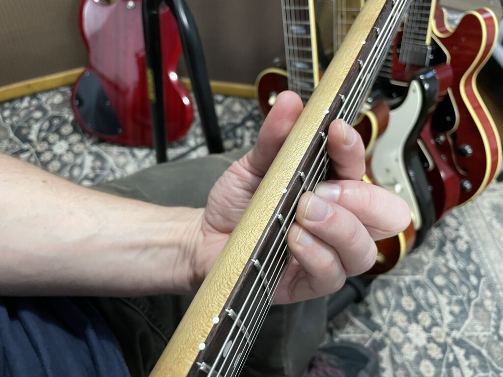 Hand Position on a Guitar to Show How to Play a Barre Chord - Green Hills Guitar Studio