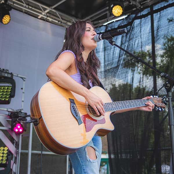 Taylor Borton playing guitar on stage