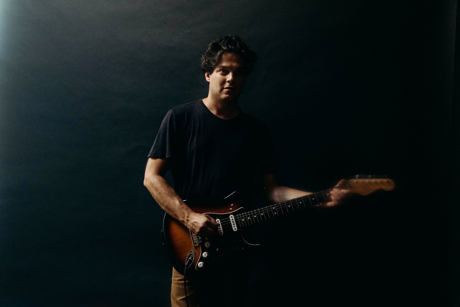 Ryan Harris Brown playing electric guitar